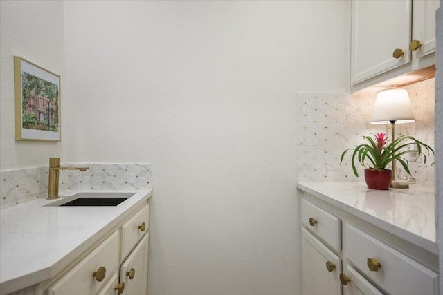 bathroom with tasteful backsplash and vanity