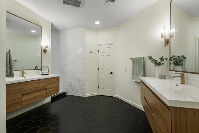 full bathroom featuring two vanities, visible vents, a sink, and tile patterned floors