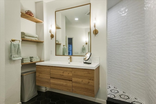 bathroom featuring tiled shower, backsplash, tile patterned flooring, and vanity