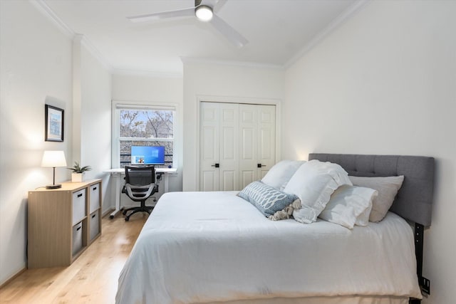 bedroom featuring a ceiling fan, a closet, crown molding, and light wood finished floors