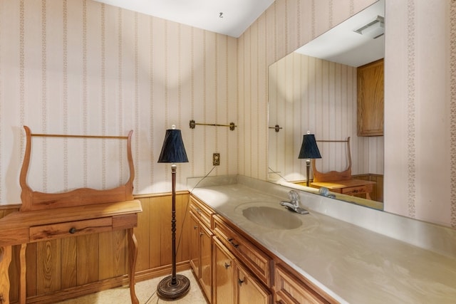 bathroom with vanity and wood walls