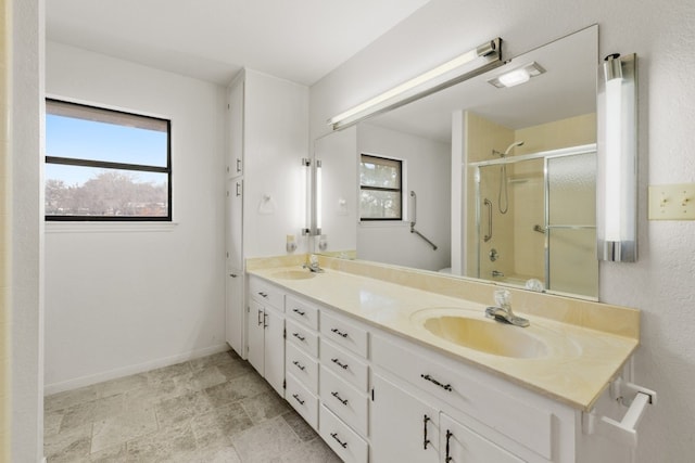 bathroom with shower / bath combination with glass door and vanity