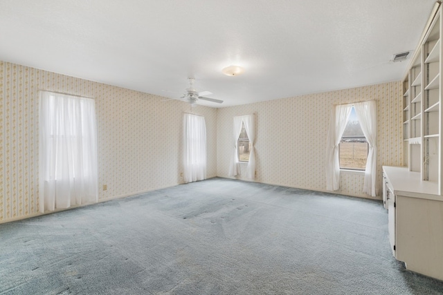 empty room featuring light colored carpet and ceiling fan