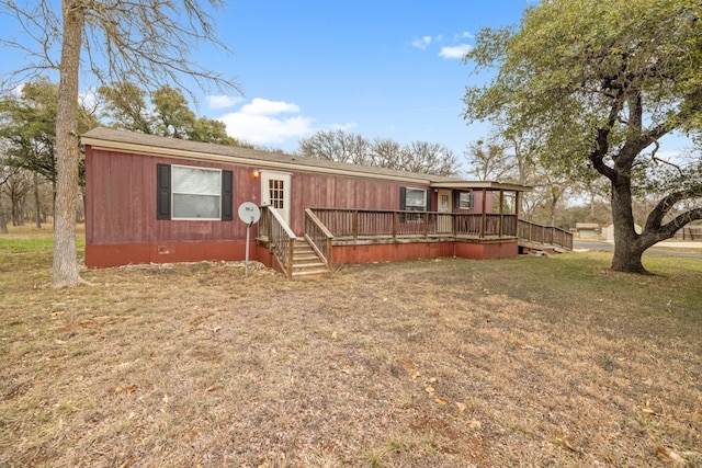 manufactured / mobile home with a deck and a front yard