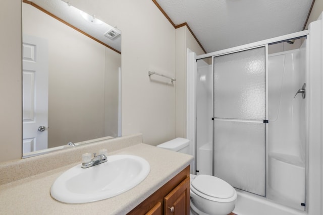 bathroom featuring a textured ceiling, walk in shower, vanity, and toilet