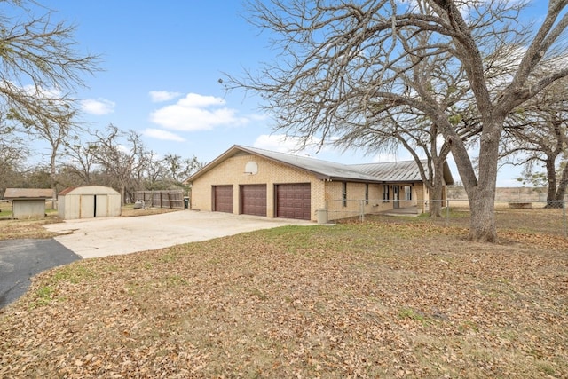 view of side of property with a garage and a shed