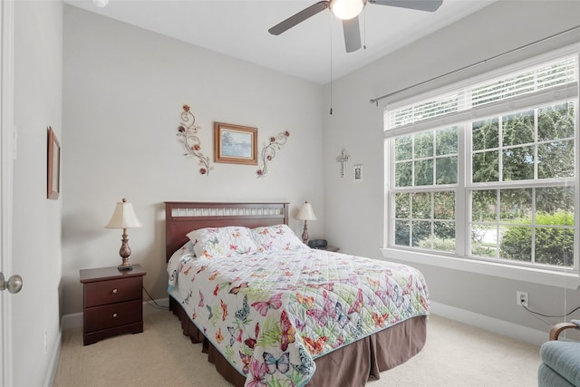 bedroom featuring ceiling fan and light carpet