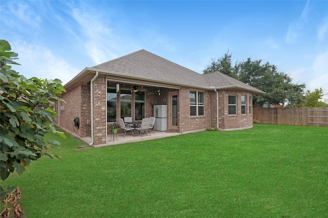 rear view of property with a patio area and a lawn