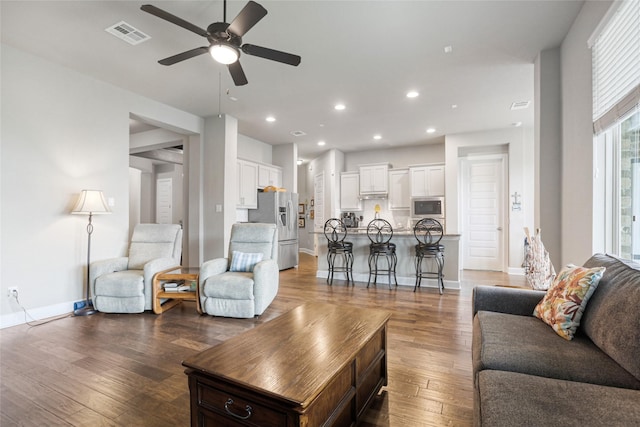 living room with hardwood / wood-style flooring and ceiling fan