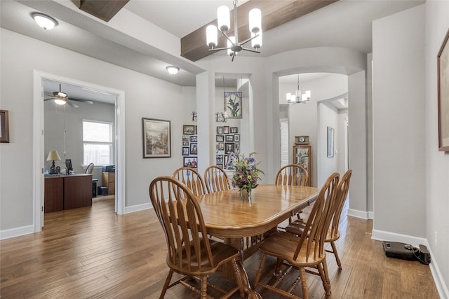 dining area with hardwood / wood-style floors and a chandelier