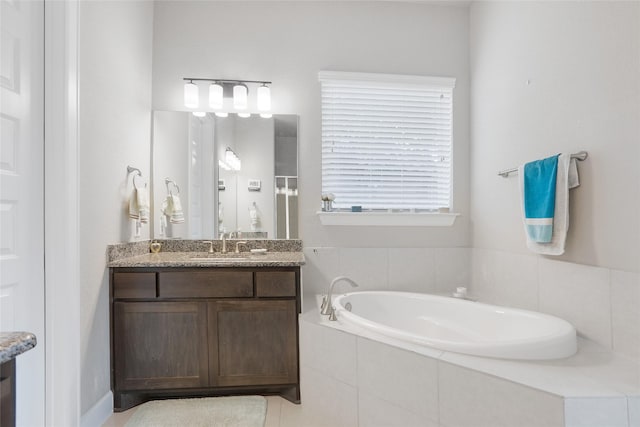 bathroom with vanity and a relaxing tiled tub