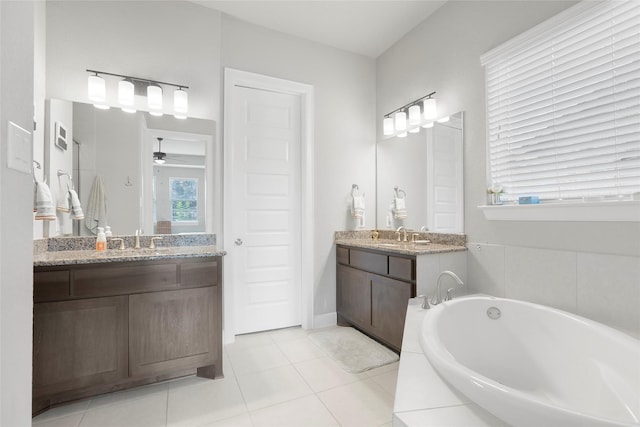 bathroom with vanity, ceiling fan, tile patterned floors, and a relaxing tiled tub