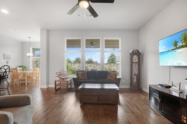 living room with ceiling fan and dark hardwood / wood-style floors