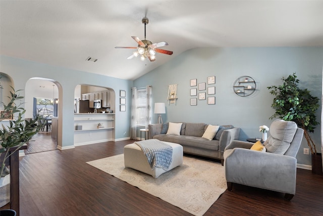 living room with lofted ceiling, ceiling fan, a wealth of natural light, and dark hardwood / wood-style flooring