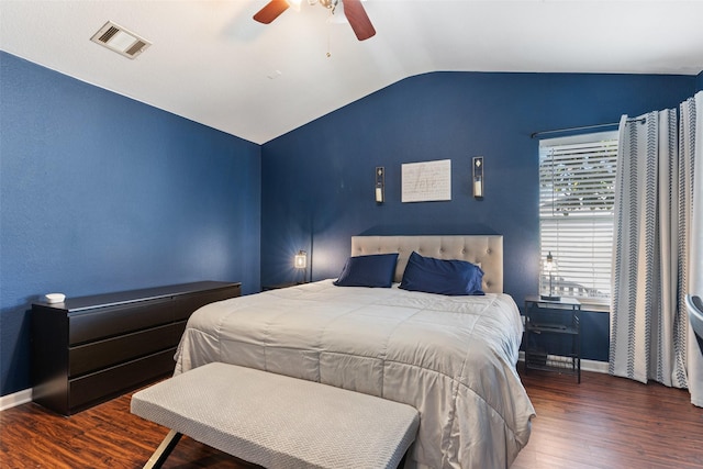 bedroom with ceiling fan, dark wood-type flooring, and vaulted ceiling