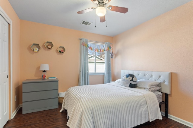 bedroom with a closet, ceiling fan, and dark hardwood / wood-style flooring