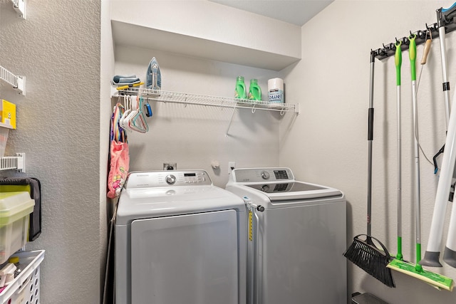 clothes washing area with washing machine and clothes dryer