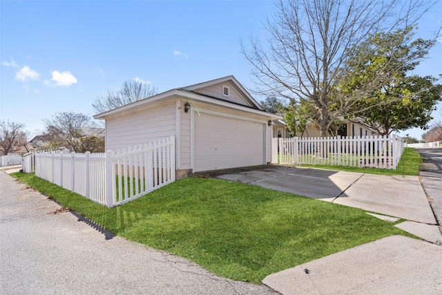 view of side of home with a garage and a yard