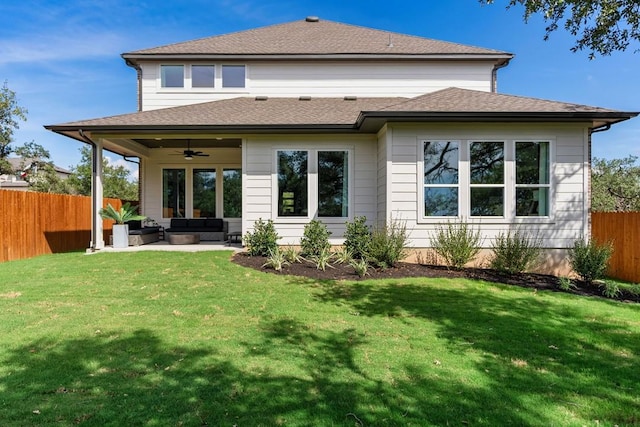 back of property with outdoor lounge area, ceiling fan, a patio, and a lawn