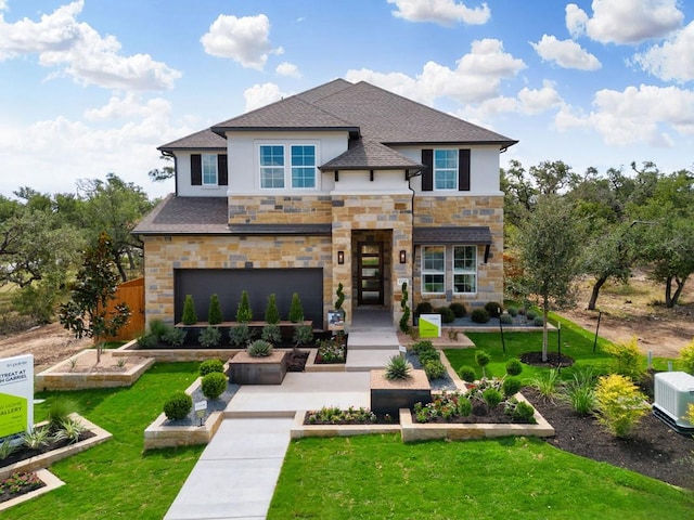 view of front of home with a garage and a front yard