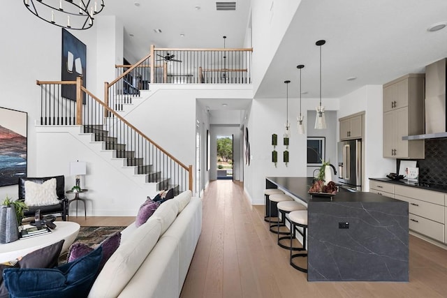 living room featuring hardwood / wood-style flooring and a high ceiling