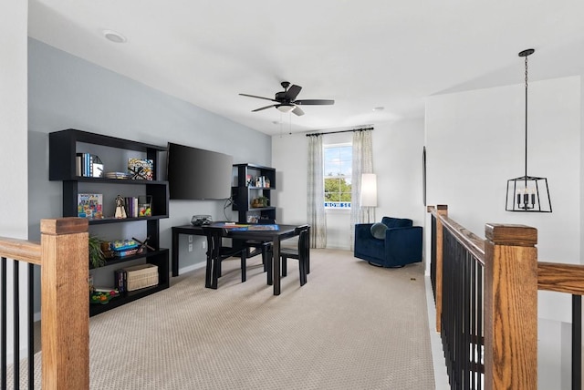 carpeted office space featuring ceiling fan