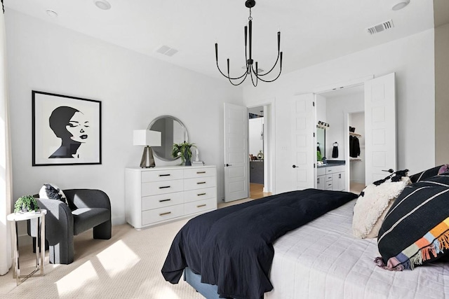 carpeted bedroom with ensuite bathroom and a notable chandelier