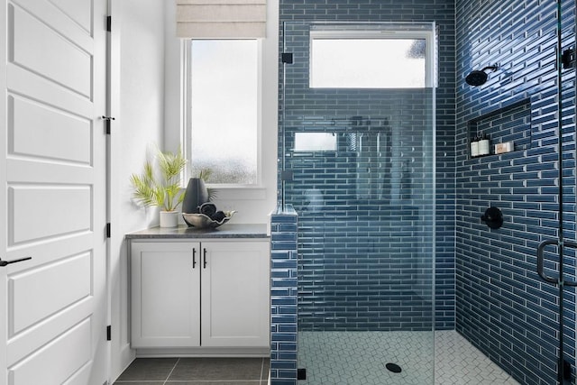 bathroom featuring tile patterned floors and a shower with door