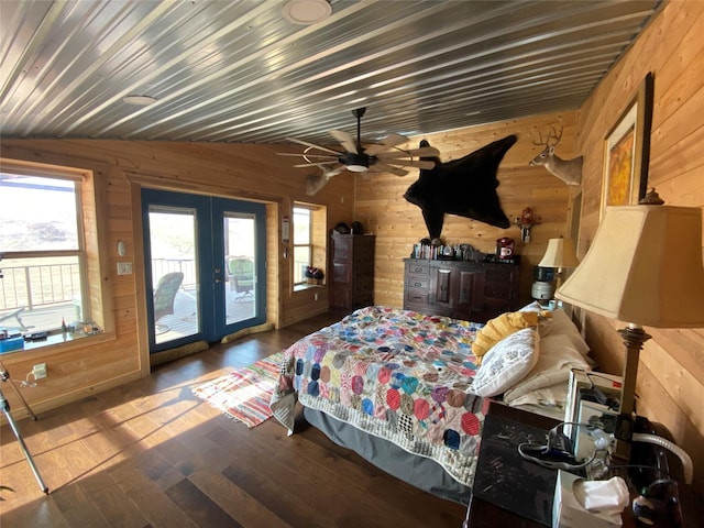 bedroom featuring lofted ceiling, wood-type flooring, french doors, access to exterior, and wood walls