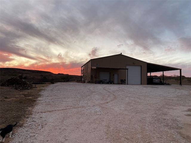 outdoor structure at dusk featuring a garage