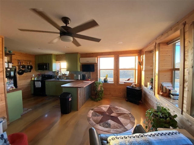 kitchen featuring green cabinets, black appliances, wooden counters, and wooden walls