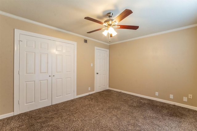 unfurnished bedroom with crown molding, carpet flooring, a closet, and ceiling fan