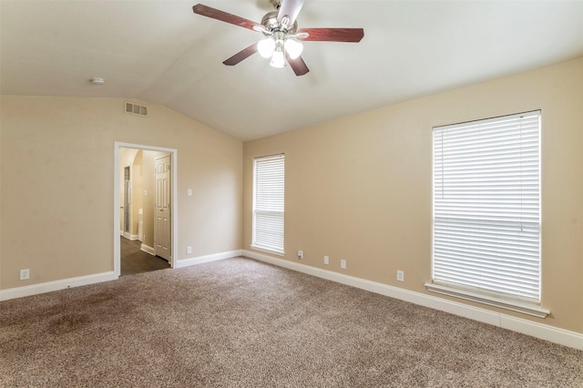 carpeted empty room with ceiling fan and lofted ceiling