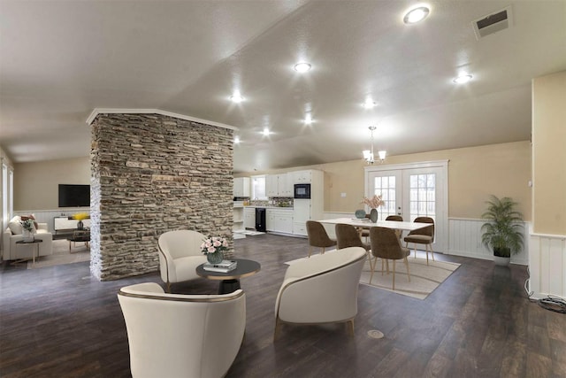 living room with french doors, dark wood-type flooring, and lofted ceiling