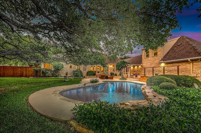 pool at dusk with a lawn