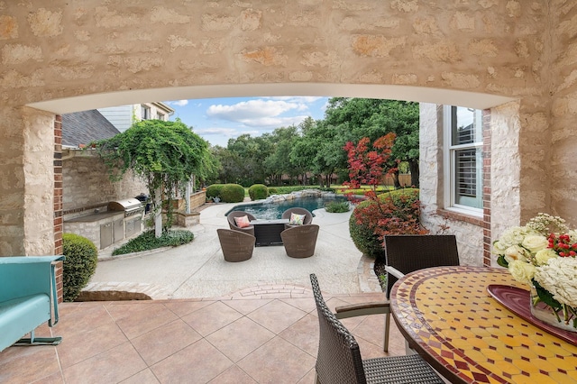 view of patio / terrace featuring an outdoor kitchen and a grill