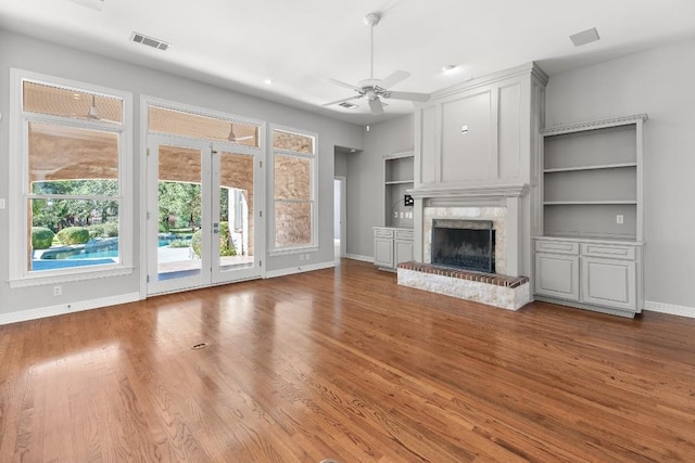 127 Roberts Cir, Georgetown, TX 78633 - unfurnished living room with baseboards, ceiling fan, a high end fireplace, and wood finished floors
