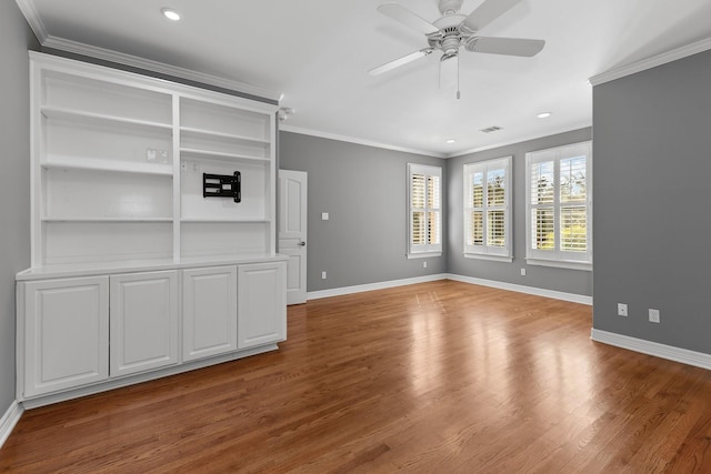 unfurnished living room with crown molding, wood-type flooring, and ceiling fan