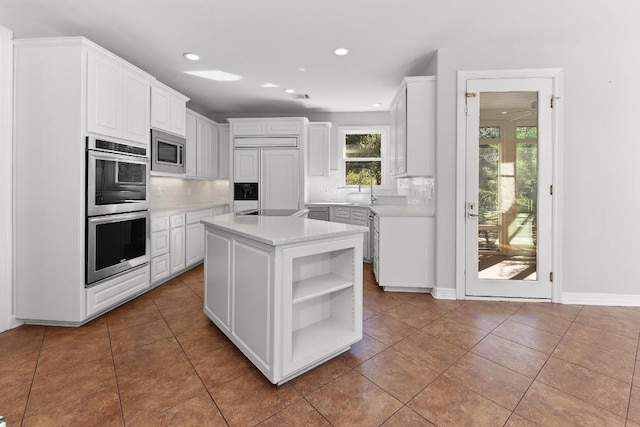 127 Roberts Cir, Georgetown, TX 78633 - kitchen with built in appliances, recessed lighting, decorative backsplash, white cabinetry, and light countertops