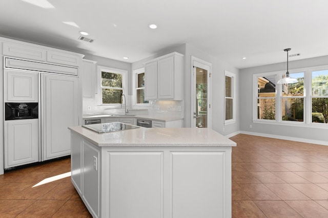 kitchen featuring white cabinetry, hanging light fixtures, backsplash, paneled fridge, and light tile patterned flooring