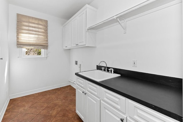 127 Roberts Cir, Georgetown, TX 78633 - laundry room featuring washer hookup, baseboards, cabinet space, and dark tile patterned floors