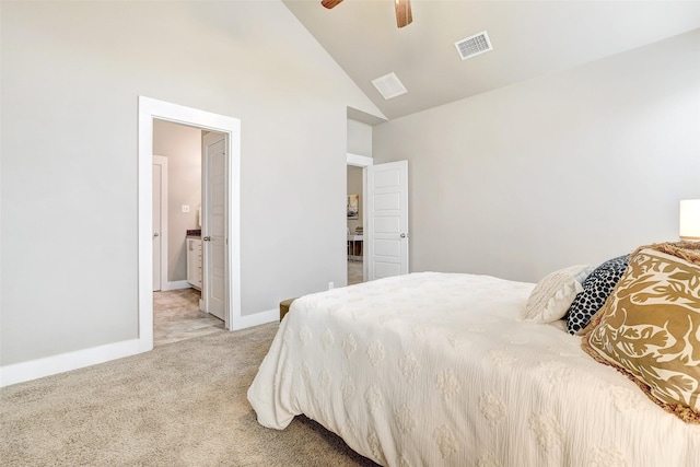 carpeted bedroom with ceiling fan, ensuite bathroom, and high vaulted ceiling