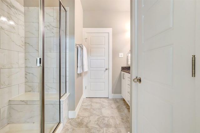 bathroom with vanity and a shower with door