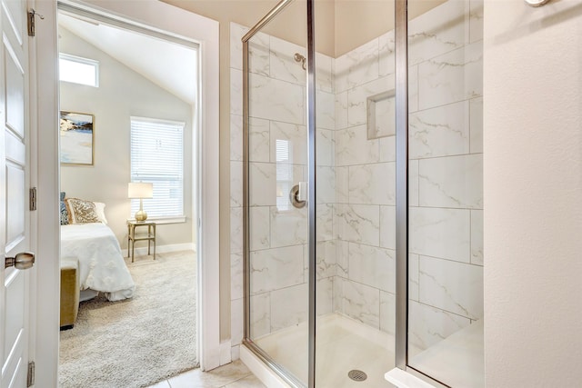 bathroom with a wealth of natural light, tile patterned floors, walk in shower, and lofted ceiling