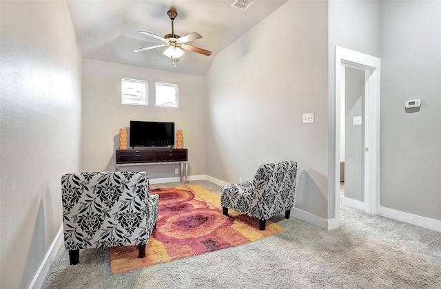 sitting room with carpet floors, vaulted ceiling, and ceiling fan