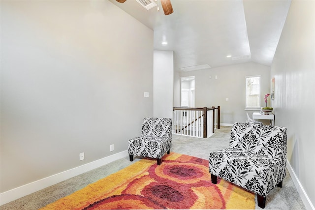 living area with ceiling fan, carpet, and lofted ceiling