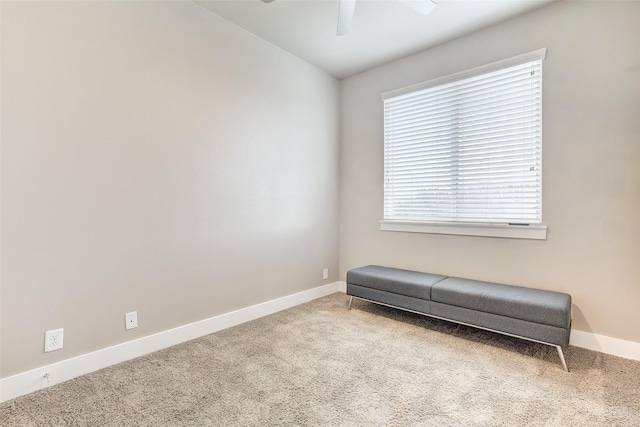 unfurnished room featuring ceiling fan and carpet flooring