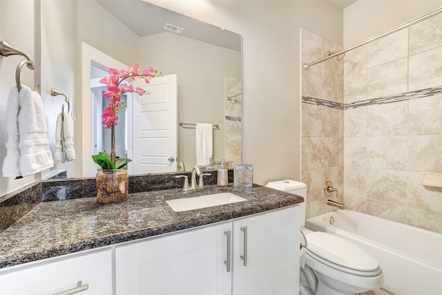 full bathroom with vanity, toilet, and tiled shower / bath combo