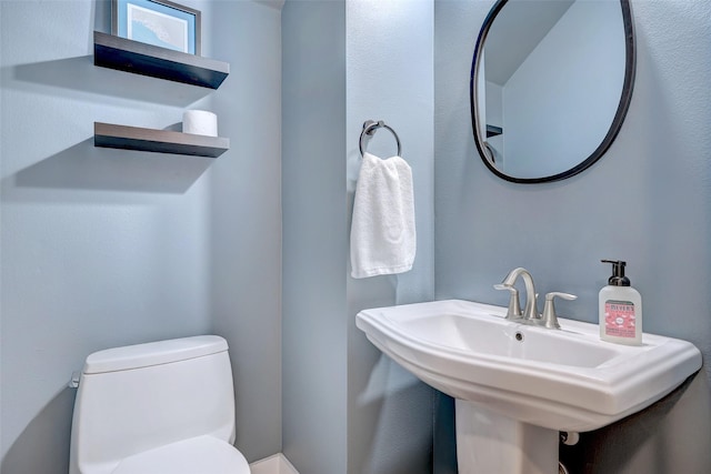 bathroom featuring sink and toilet