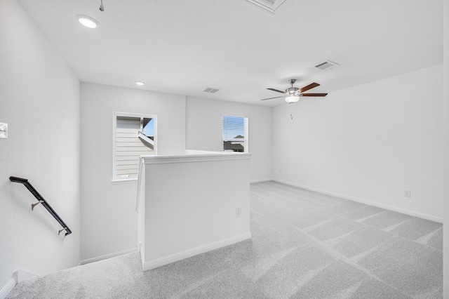 empty room with baseboards, recessed lighting, visible vents, and light colored carpet